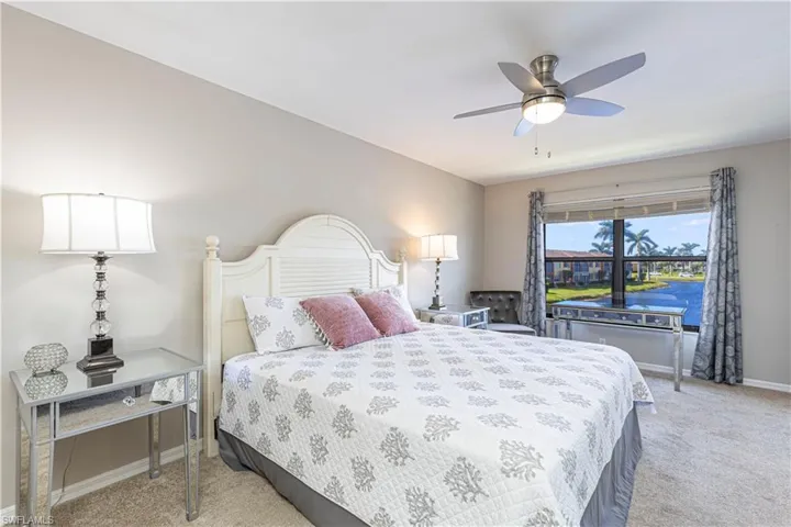 Primary Bedroom featuring a water view, newer ceiling fan