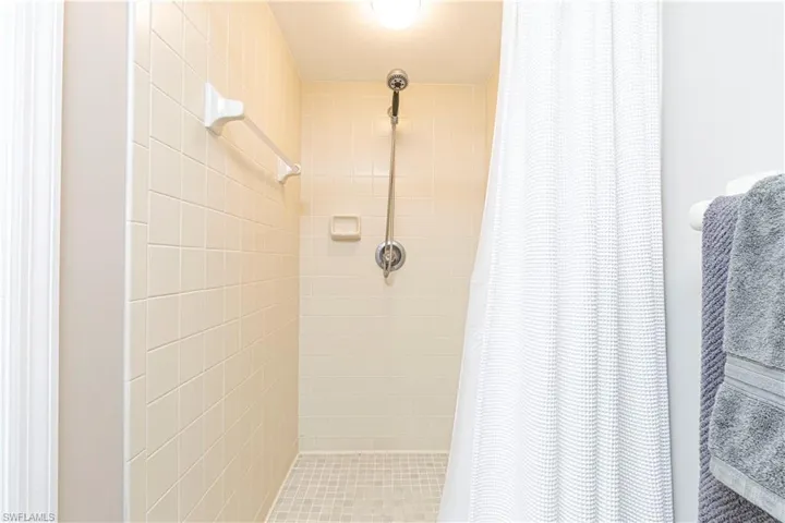 Full bathroom with a shower stall