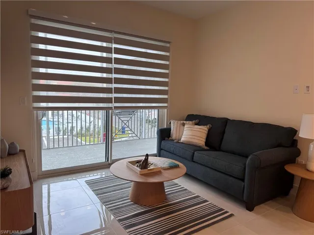 Living room with light tile patterned flooring