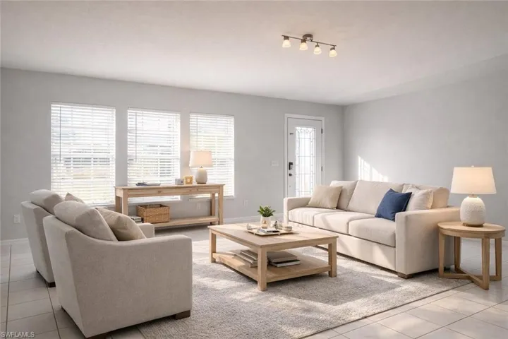 Living area with light tile patterned floors and plenty of natural light