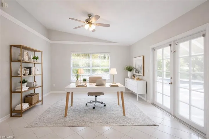 Office with lofted ceiling, french doors, ceiling fan, and light tile patterned flooring