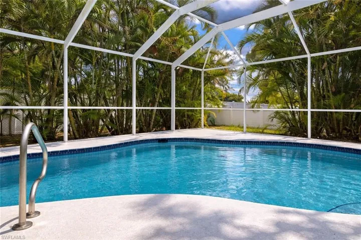 Swimming pool with glass enclosure