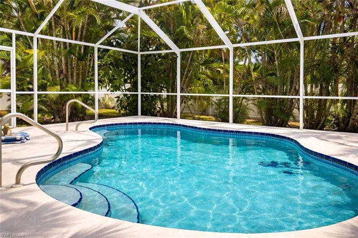 Swimming pool with glass enclosure and a sunroom