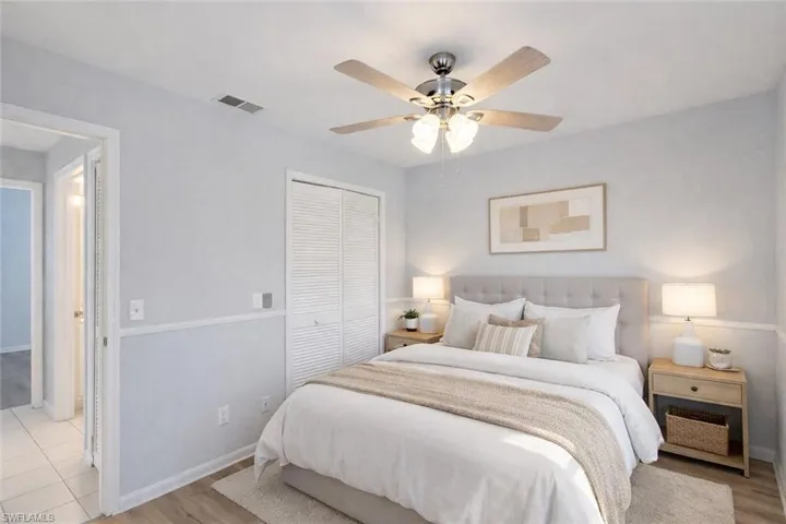 Bedroom featuring light wood-style floors, a closet, and a ceiling fan