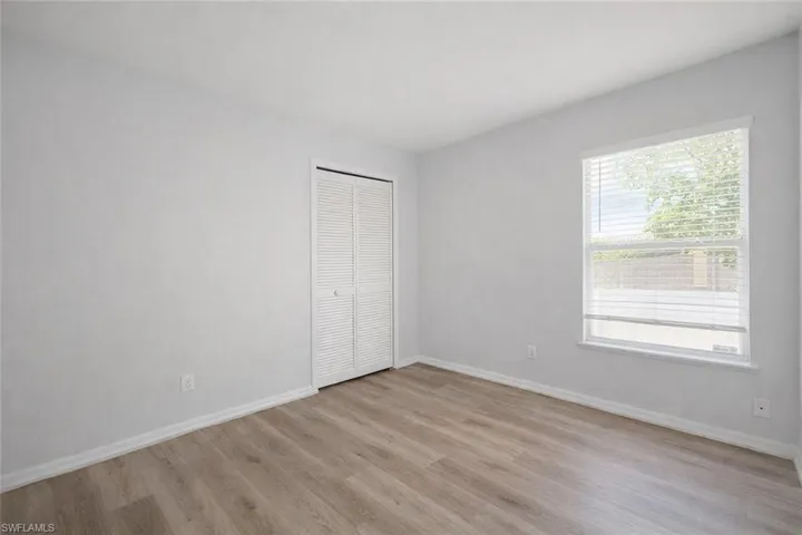 Unfurnished bedroom featuring light wood finished floors and a closet