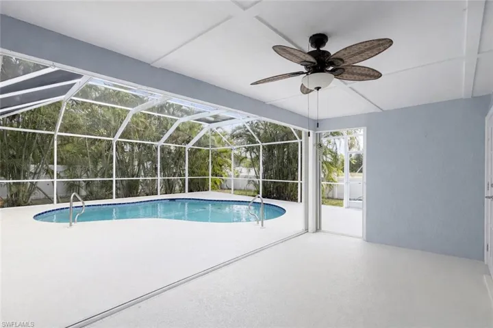Swimming pool with a sunroom, a patio, and a lanai