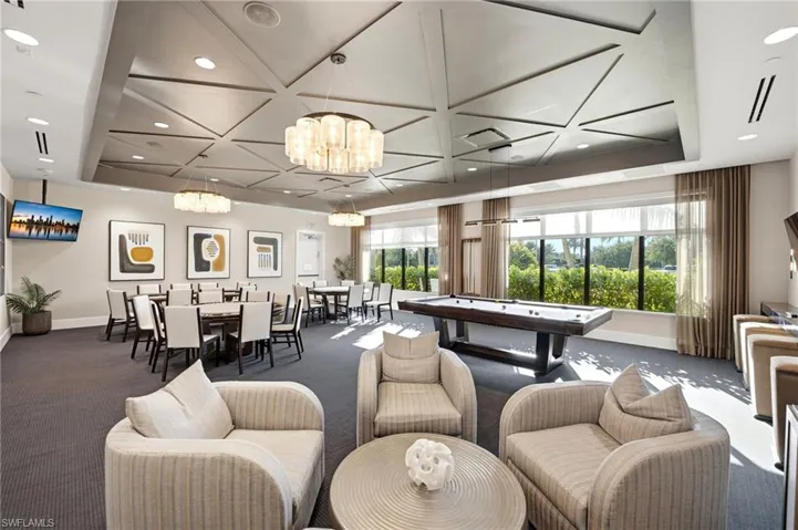 Billards Room. Geometric coffered ceiling, tiered glass chandeliers, floor-to-ceiling windows, and recessed lighting.