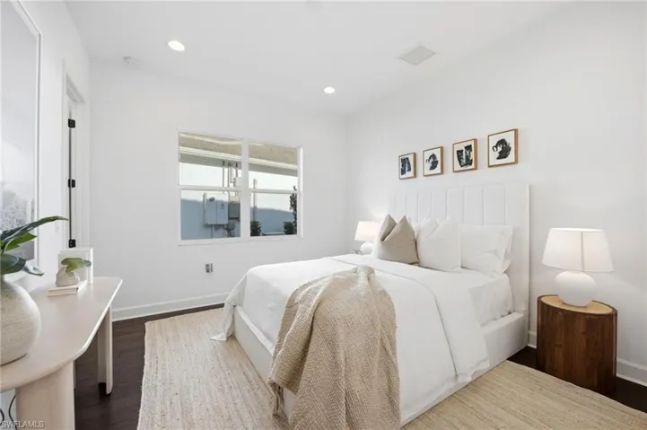 Neutral interior featuring wood-finish flooring, recessed lighting, and a large horizontal window