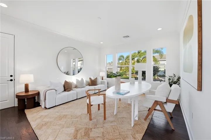 Bright interior space featuring dark wood-finish flooring, recessed lighting, and expansive windows