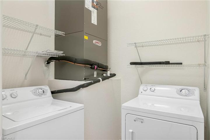 Laundry room with additional storage space.