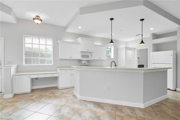 Kitchen includes built in desk area and plenty of cabinet space.