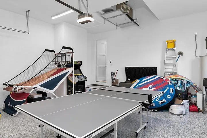 Playroom featuring a garage and speckle patterned floor