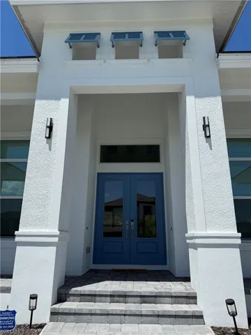 Property entrance featuring french doors and stucco siding