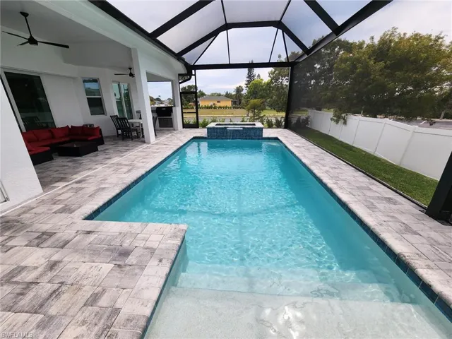 View of pool with a ceiling fan, a patio, an outdoor hangout area, a pool with connected hot tub, and a sunroom