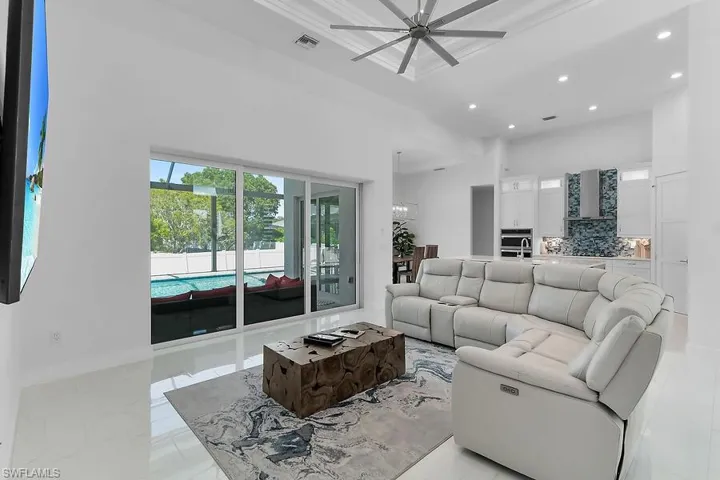 Living area featuring recessed lighting and a ceiling fan