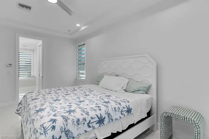 Bedroom featuring recessed lighting, ensuite bath, and a ceiling fan