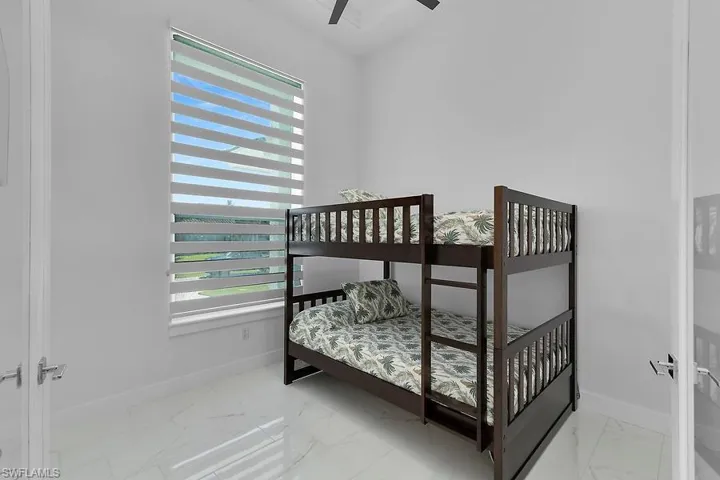 Study/Flex Room featuring light marble finish floors and ceiling fan