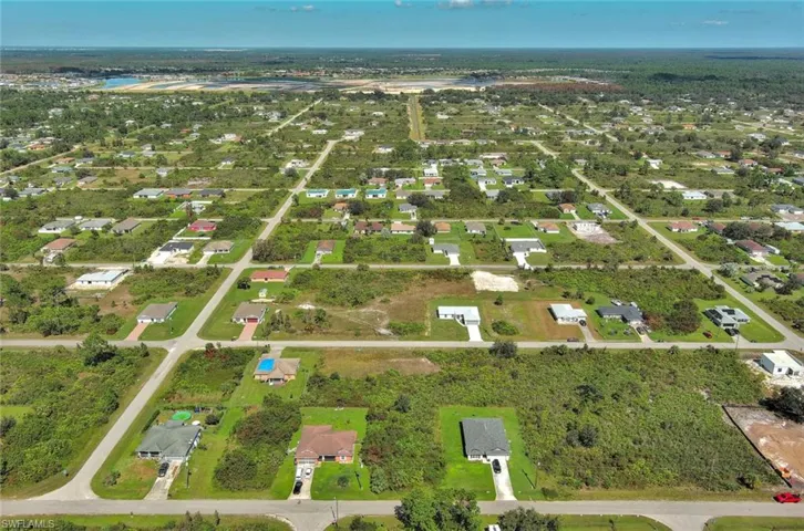 Aerial overview of property's location featuring nearby suburban area