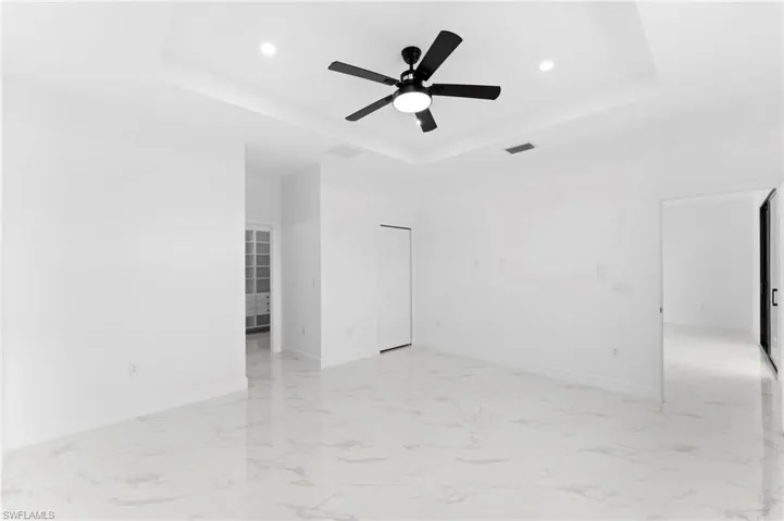 Unfurnished room with light marble finish floors, ceiling fan, and recessed lighting