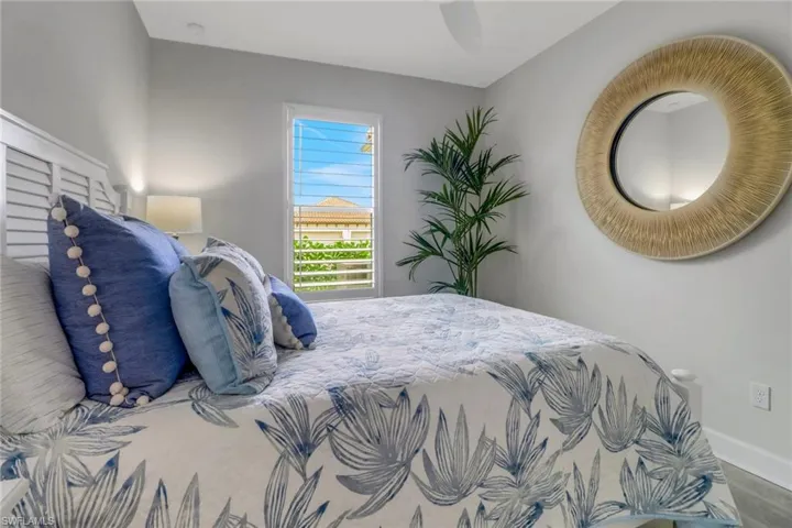 Bedroom with ceiling fan and baseboards
