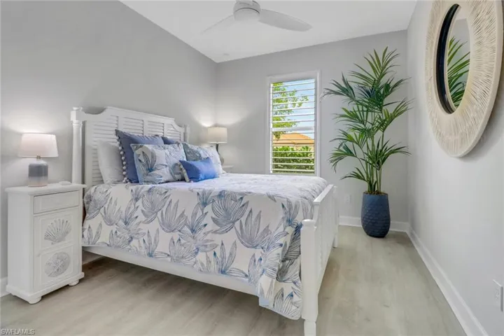 Bedroom with baseboards, ceiling fan, and light wood finished floors