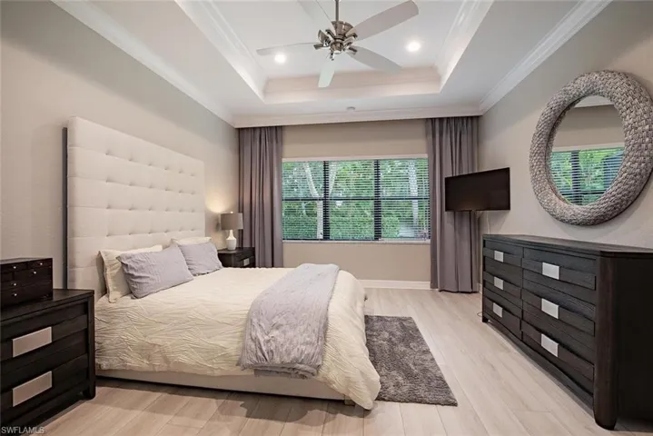 Elegant Master Bedroom with wood look flooring