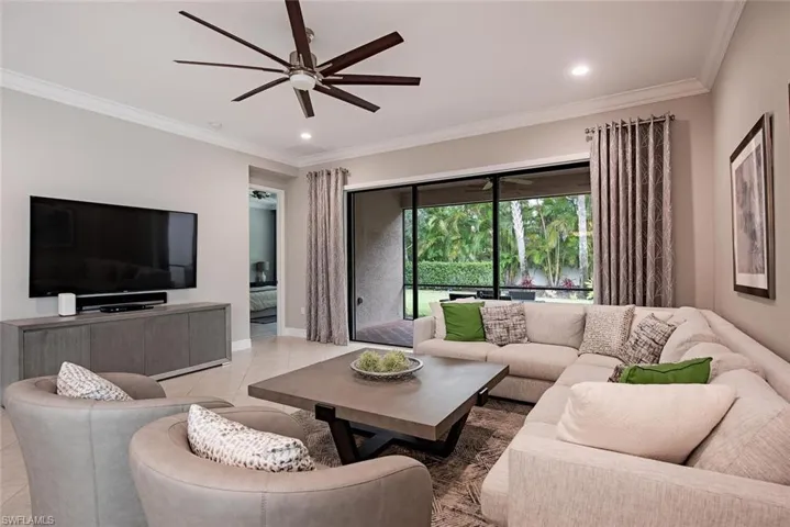 Living Area opens to screened lanai and private yard.