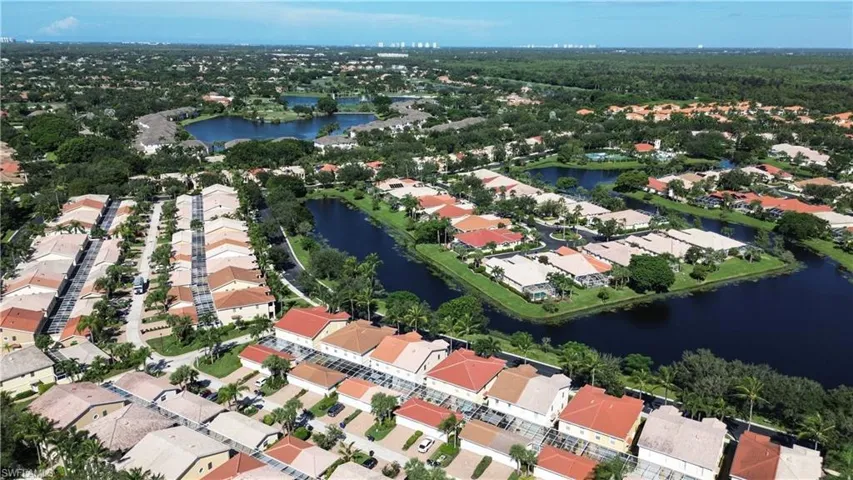 Aerial view of property's location with a large body of water and nearby suburban area