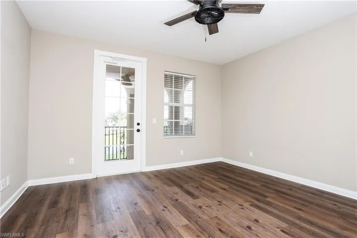 Spare room featuring dark wood finished floors and ceiling fan