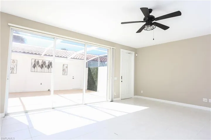 Empty room featuring light tile patterned floors and ceiling fan