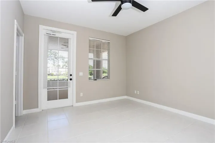 Unfurnished room featuring light tile patterned flooring and a ceiling fan
