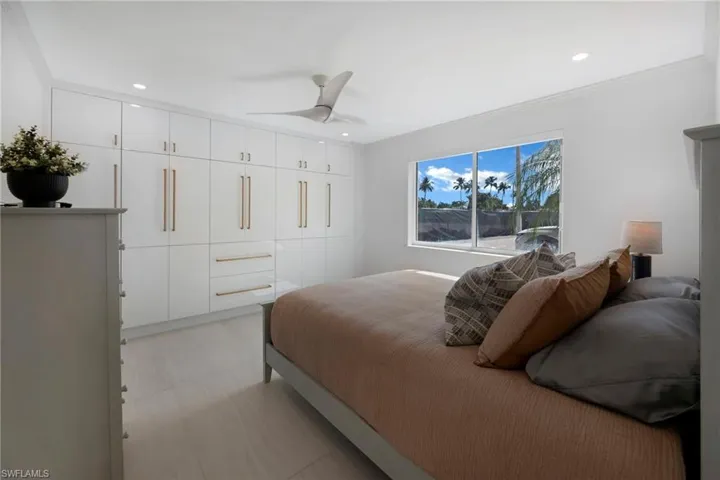Bedroom featuring ornamental molding, a closet, and ceiling fan