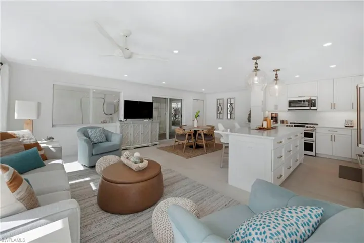 Living room featuring ceiling fan and light hardwood / wood-style flooring