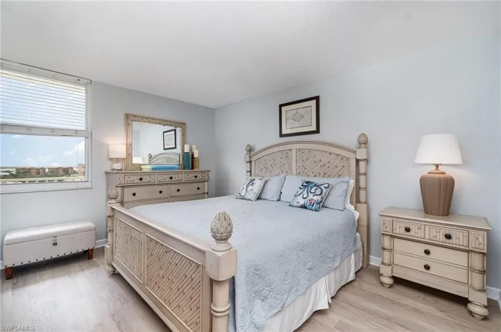 Bedroom with light wood finished floors and baseboards