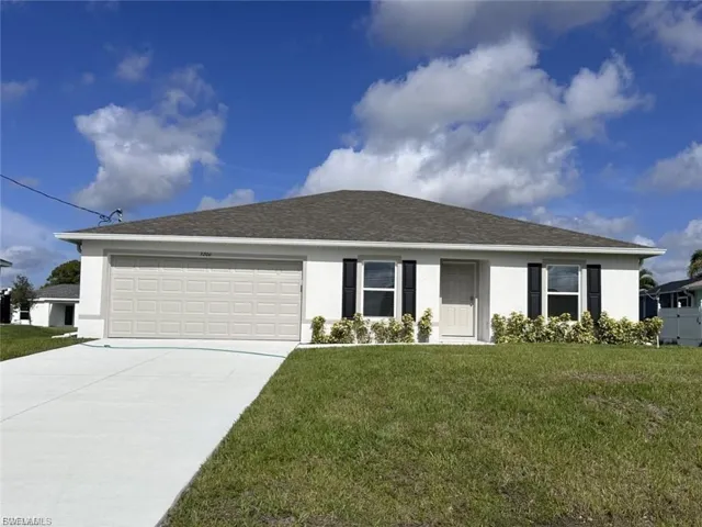 Single story home with stucco siding, a front yard, driveway, a garage, and a shingled roof