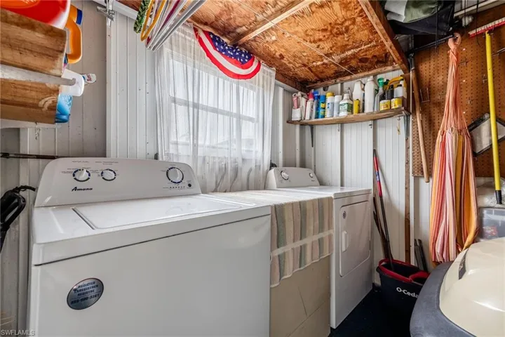 Laundry room with washer and clothes dryer