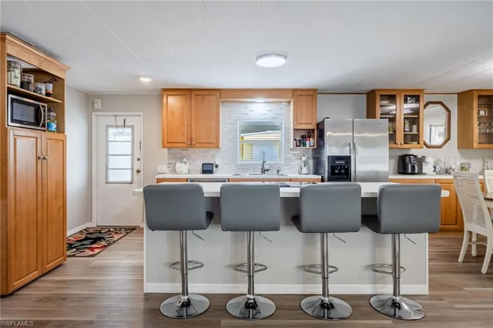 Kitchen featuring light wood-style flooring, appliances with stainless steel finishes, and light countertops