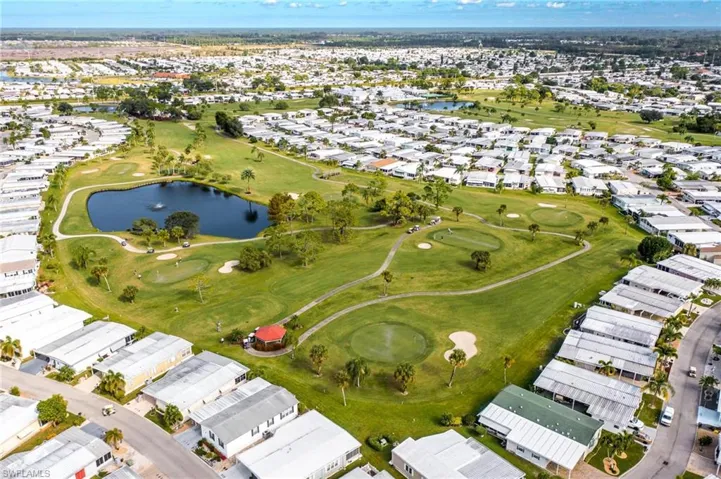 Aerial view featuring a water view, golf course view, and a residential view
