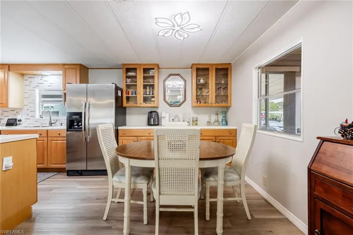 Dining area with baseboards and light wood-style floors