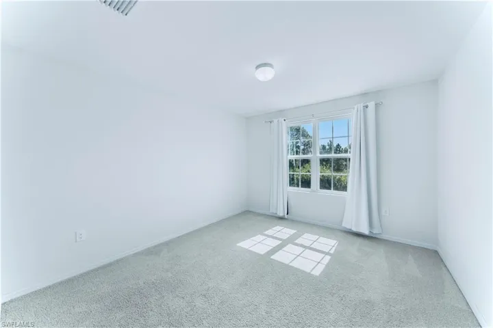 Unfurnished room featuring baseboards and carpet flooring