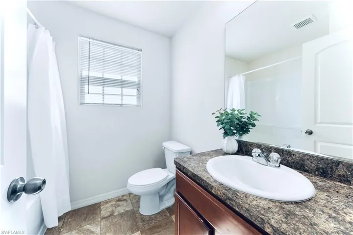 Full bath with vanity and curtained shower