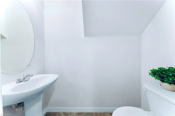 Half bath featuring toilet and tile patterned floors