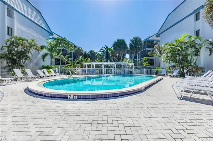 Community pool with a patio