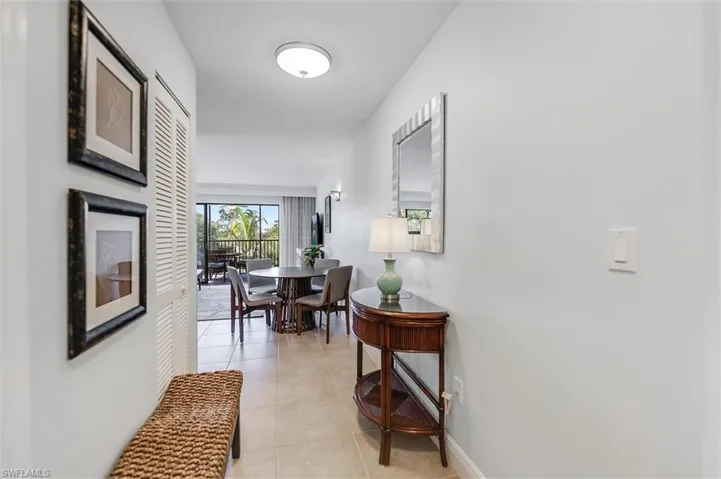 Corridor with light tile patterned floors and baseboards
