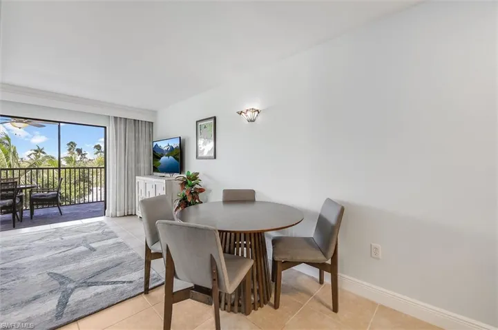 Dining area featuring light tile patterned floors and baseboards