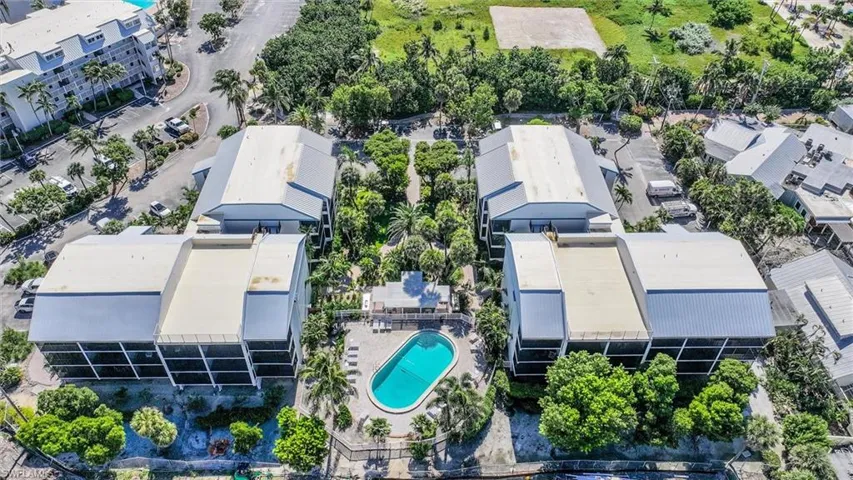 Aerial view of a pool area and apartment complex