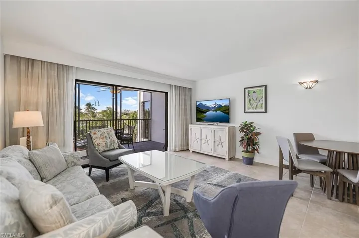 Tiled living room featuring baseboards