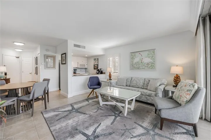 Living area with light tile patterned floors and baseboards