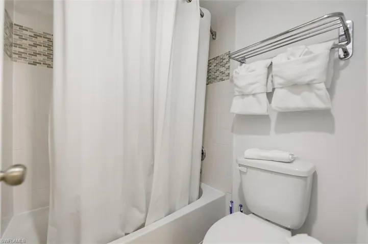 Full bathroom featuring shower / tub combo and toilet