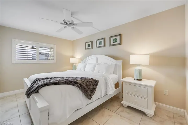 Bedroom featuring baseboards and ceiling fan